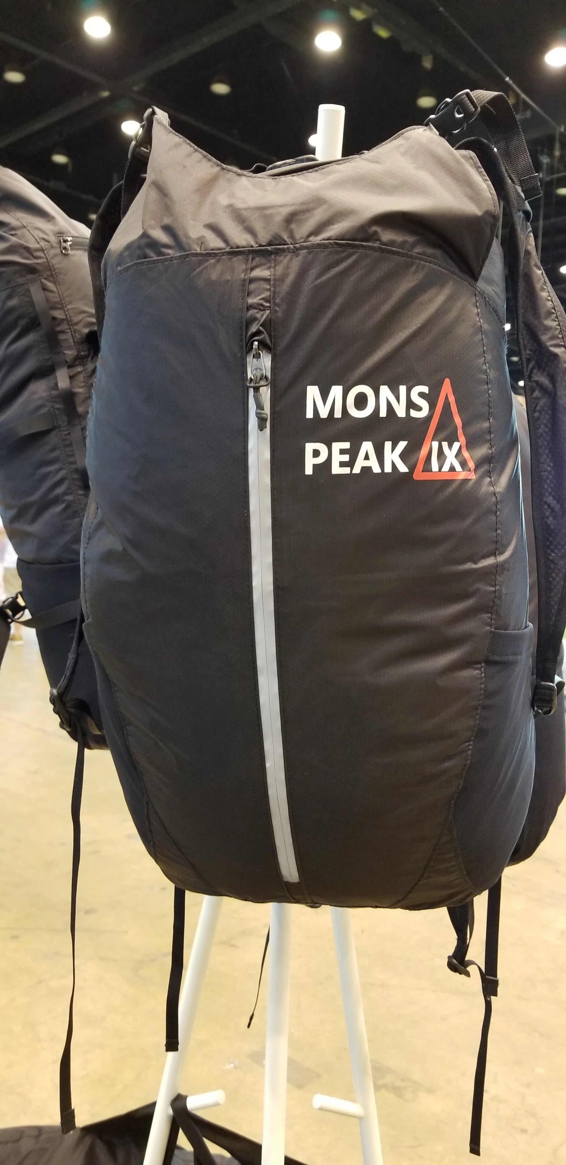 Mons Peak IX 23L black and orange daypack front view with padded straps and pockets

