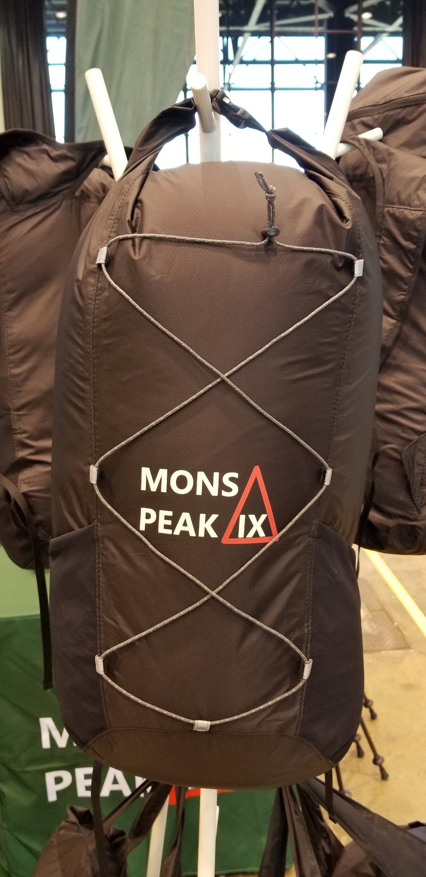 Mons Peak IX 20L black and orange daypack front view with padded straps and pockets"
