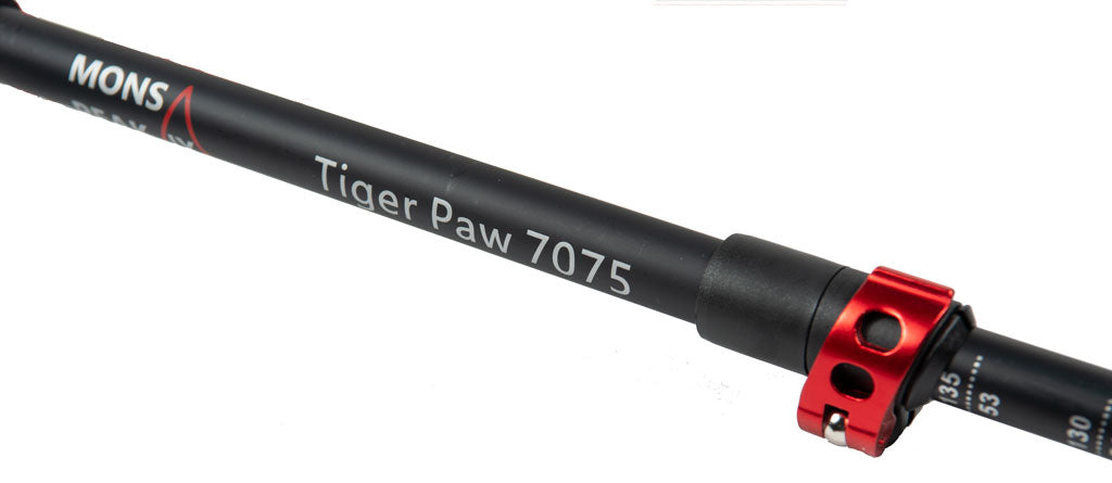Black carbon fiber Tiger Paw trekking pole section showing Mons Peak branding, red twist-lock mechanism, and measurement indicators