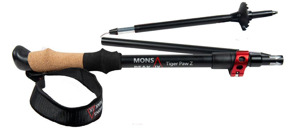 Mons Peak IX Tiger Paw Z collapsible carbon trekking poles folded compact with cork grip, black shaft, red quick-lock collar, adjustable wrist strap, and carbide tip with mud basket