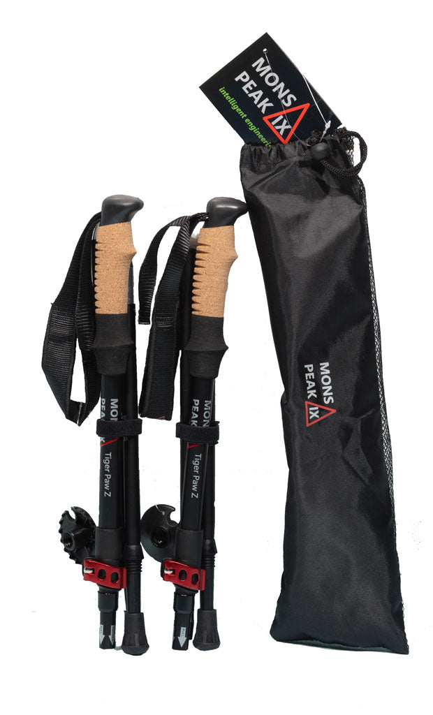 Mons Peak IX Tiger Paw Z carbon trekking poles collapsed in storage mode with cork grips, black shafts, red quick-lock collars, adjustable wrist straps, mud baskets, and included black carry bag