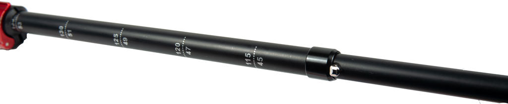 Close-up of Mons Peak IX Tiger Paw Z carbon trekking pole shaft showing height adjustment markings from 45 to 130 cm, red quick-lock collar, and silver locking pin