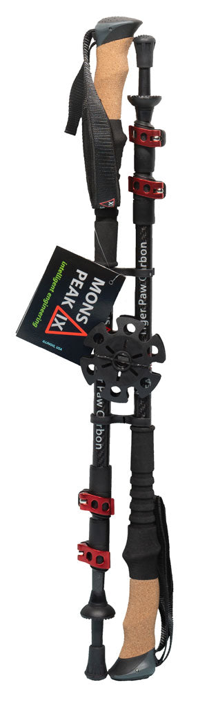 Mons Peak IX Tiger Paw Z carbon trekking pole fully extended with natural cork grip, black shaft, multiple red quick-lock collars, adjustable wrist strap, large mud/snow basket, carbide tip, and branded 'intelligent engineering' hang tag